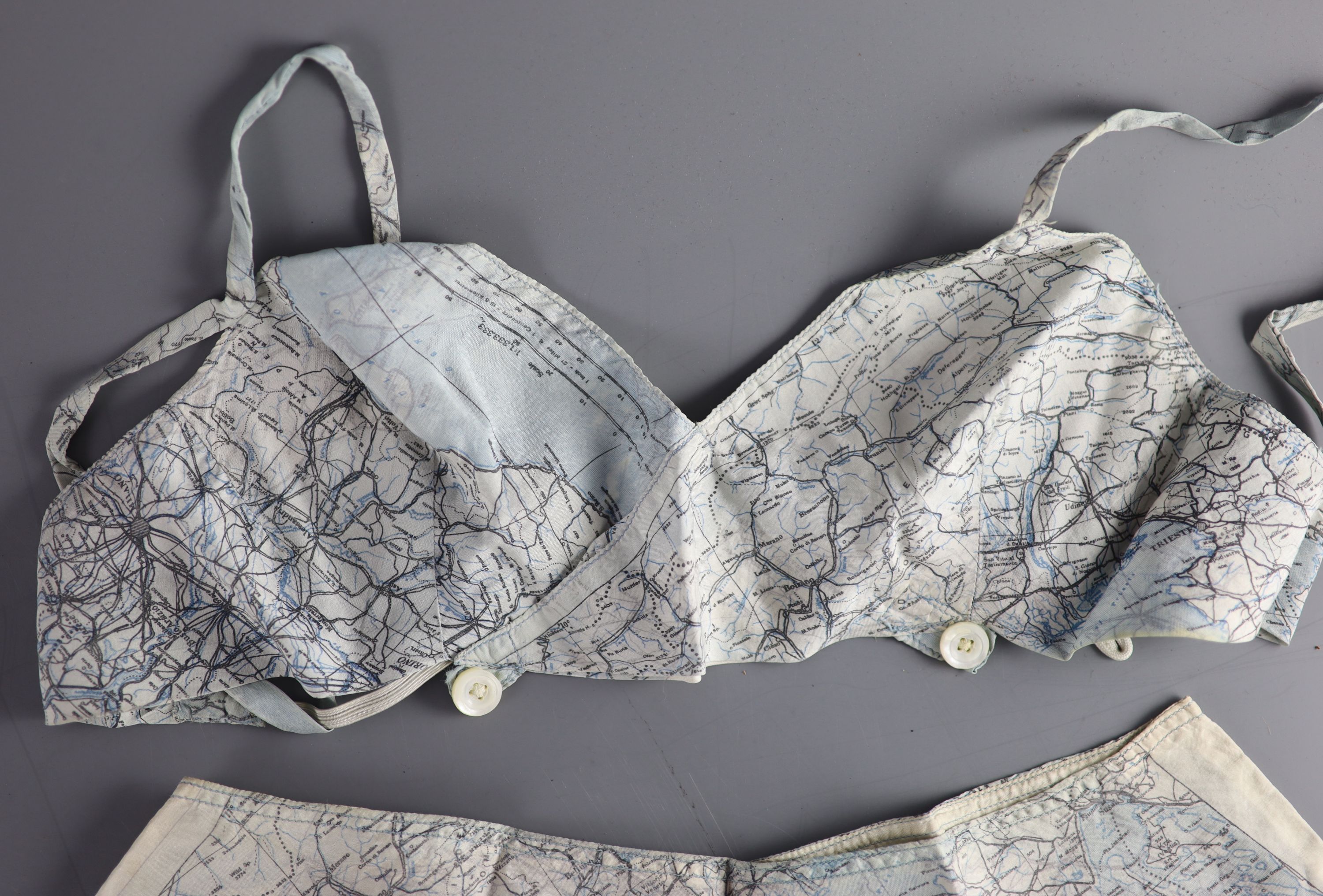 A novelty bra and cami knicker set, made from a silk printed escape map of Italy, used in the Second World War